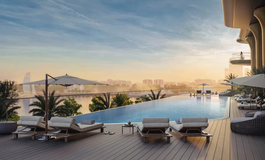 Sun loungers and shaded seating on the infinity pool terrace at Jumeirah Residences Al Maryah Island