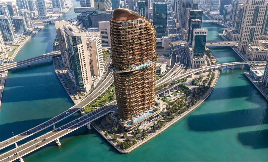 Aerial view of the Jumeirah Residences tower on Al Maryah Island, framed by turquoise water and bridges