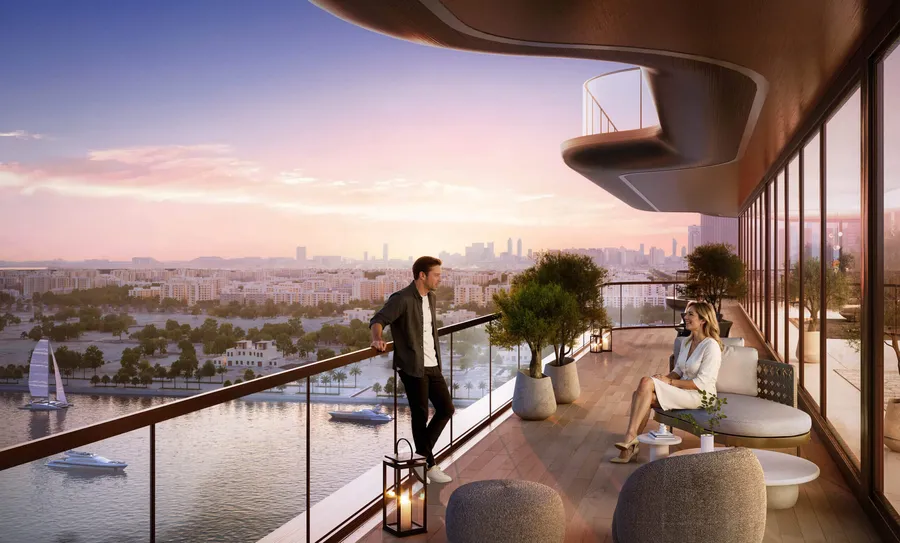Residents on a private terrace at Jumeirah Residences Al Maryah Island overlooking the canal at sunset